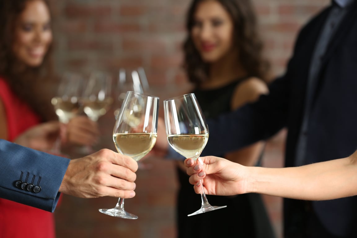 People Doing Toast with Glasses of White Wine